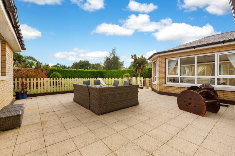Part of the rear garden is landscaped with a patio for entertaining
