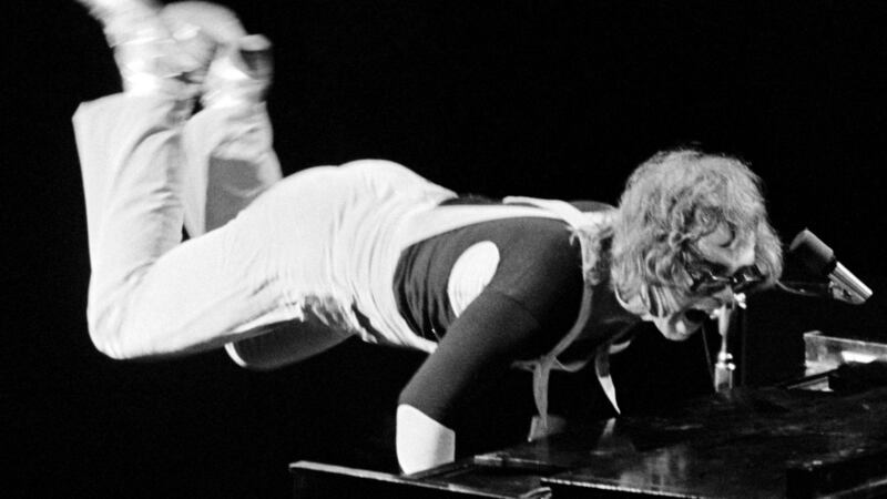 Elton John on stage with legs in the air at Fillmore East, NYC. April 9, 1971. Photograph: Bob Gruen