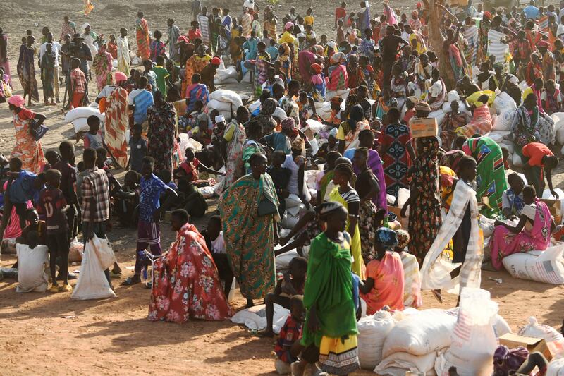 Internally displaced women in South Sudan wait at a food distribution centre as they receive their monthly food rations distributed by the World Food Programme in Bentiu in February 2023. Photograph: Simon Maina/AFP via Getty Images)