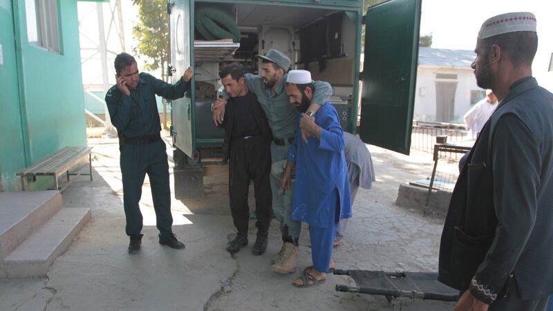 An Afghan policeman who was wounded in a rocket attack, is shifted to a polling station, during the presidential elections, in Ghazni, Afghanistan. Photograph: Sayed Mustafa/EPA