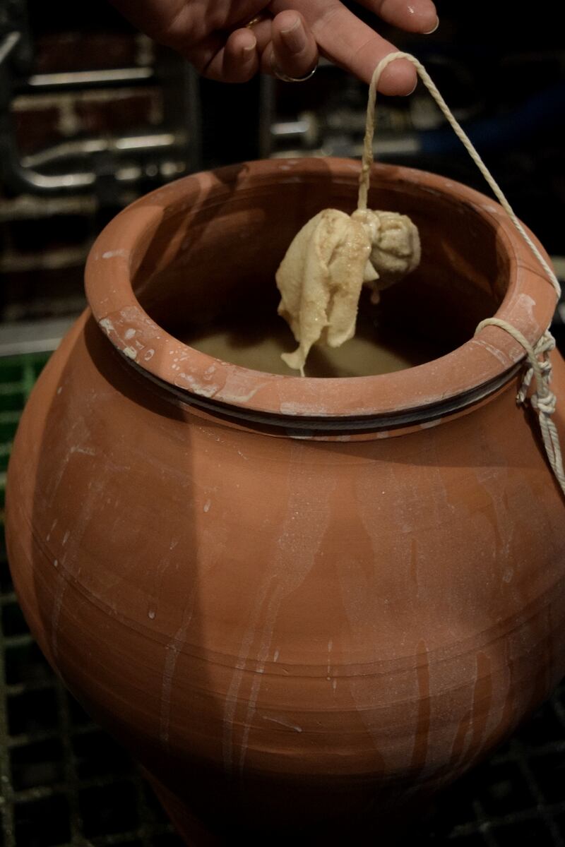Terracotta pot with ancient Egyptian beer and dukkah spice mix in muslin. Photograph: Tasha Marks