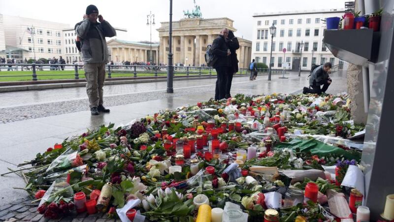 Flowers, cards, and candles have been left in front of the French Embassy at Pariser Platz in Berlin in memory of the victims of the terrorist attack on the French satirical magazine ‘Charlie Hebdo’. World leaders including chancellor Angela Merkel will attend a rally in memory of the victims in Paris tomorrow. Photograph: Rainier Jensen/EPA.