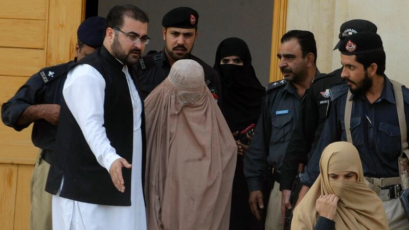 Afghan refugee woman, Sharbat Gula (C), known internationally as the ‘Afghan Girl’ leaves the court in Peshawar on November 4th, 2016. Photograph: Getty Images