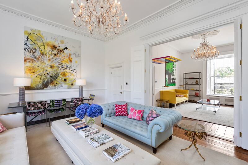 Two interconnecting drawing rooms are painted white to showcase the familys art collection