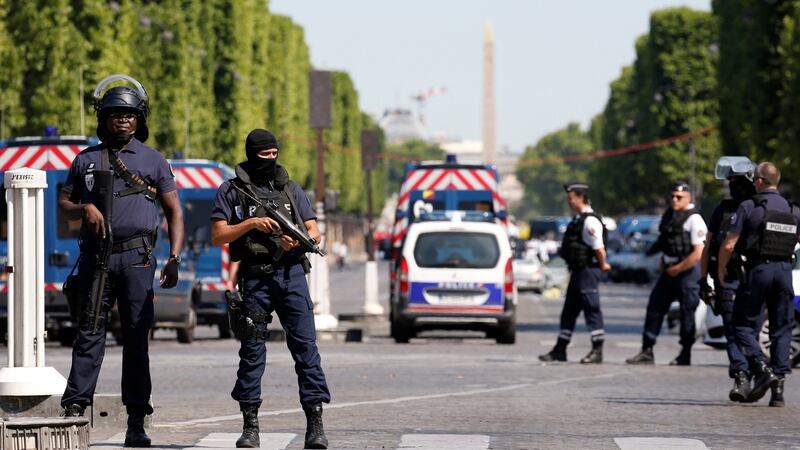 French policemen secure the area on the Champs Elysees  after an incident in Paris. Photograph: Gonzalo Fuentes/Reuters