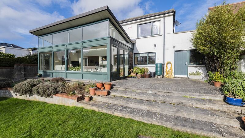 Rear view of  sun room opening  out to the patio.