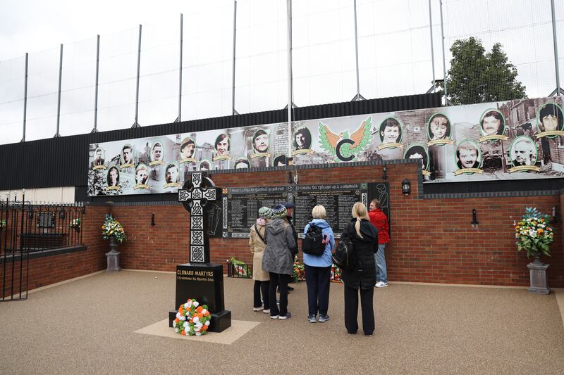 Tourists visit the Clonard Martyrs Memorial Garden, on Bombay Street, Belfast.  Behind the memorial garden is the Peace Wall between  the nationalist Falls Road and unionist Shankill Road. Photo: Bryan O’Brien