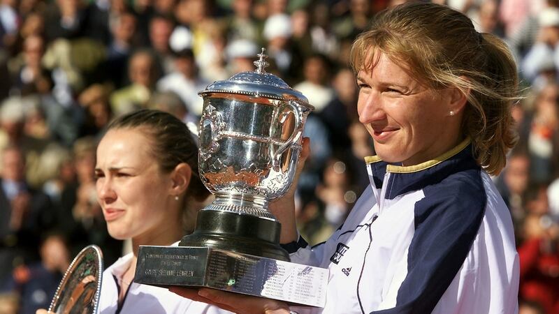 Steffi Graf  holds up the Suzanne Lenglen Cup after beating Martina Hingis. Photograph: Thomas Coex/AFP via Getty Images