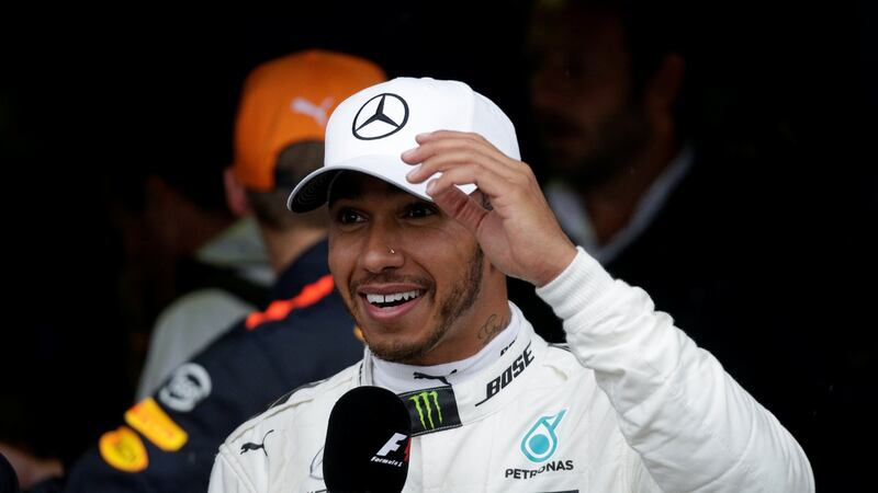 Lewis Hamilton celebrates after qualifying in pole position. Photograph:  Max Rossi/Reuters