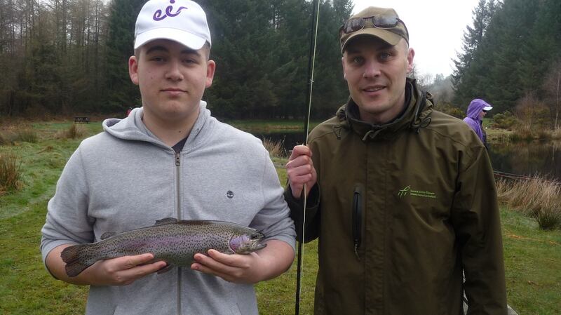 A good-sized rainbow trout for George Ciobanu (16) from Lucan, with fisheries officer Val Fitzpatrick