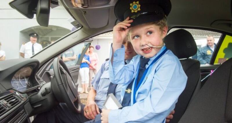 Fionn Doyle  pictured in a Garda car in Kildorrery, north Cork as part of his 7th birthday celebrations last August. Photograph: Daragh Mc Sweeney/Provision
