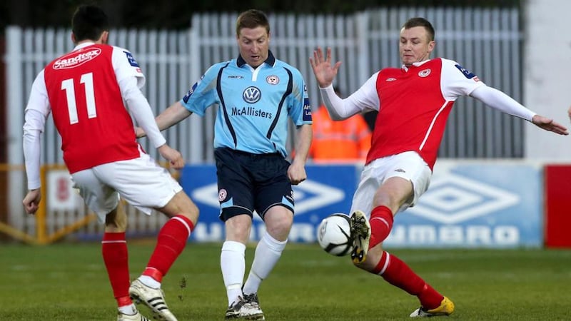 Killian Brennan (left) and Kenny Browne of St Patrick's Athletic with Phillip Hughes of Shelbourne at Richmond Park. Photograph: Ryan Byrne/Inpho