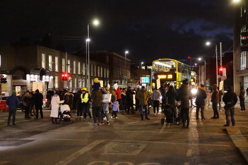 Protesters against asylum seekers being housed at the former ESB  office in East Wall stopping traffic as they protested at the Five Lamps on Amiens Street, Dublin, last December. Photograph: Dara Mac Dónaill 







