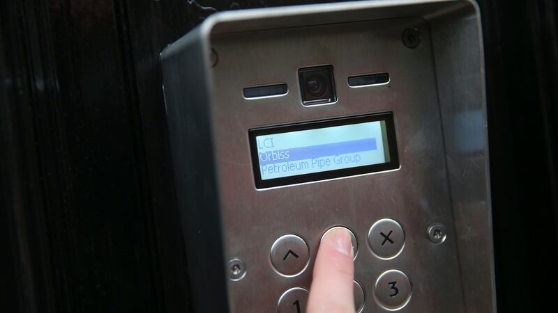 A journalist rings the bell of the building housing the offices of business consultants Orbis Business Intelligence Ltd in central London on Thursday. Photograph: Daniel Leal-Olivas/AFP/Getty Images