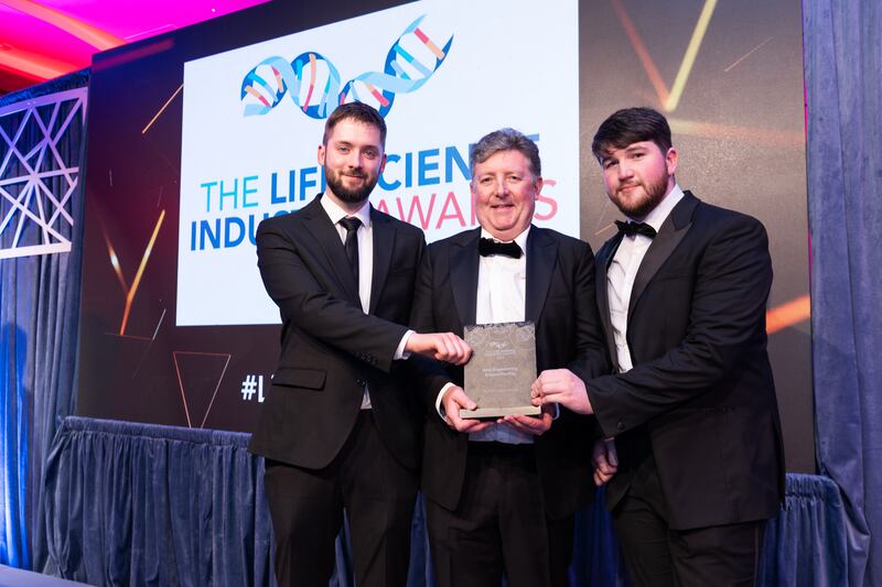 William Dolan, director at Cundall, presents the best engineering project/facility award to Ciaran Gartlan and Bartosz Nowak, WuXi Biologics Ireland