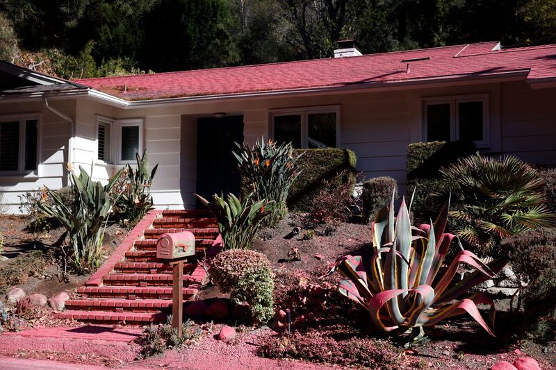 A house covered in fire retardant. Photograph: Caroline Brehman