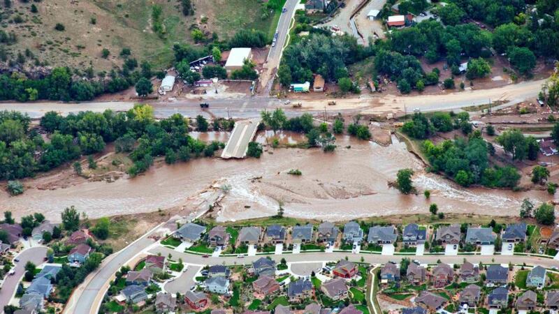 An aerial view shows flood waters and a washed-out road adjacent a suburban neighborhood in Lyons, Colorado, yesterday.  Photograph: John Wark/Reuters