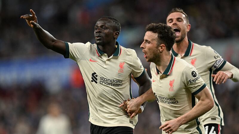 Sadio Mané  celebrates scoring Liverpool’s second goal with Jordan Henderson  and  Diogo Jota during the  Premier League match against Aston Villa at Villa Park. Photograph:  Paul Ellis/AFP via Getty Images