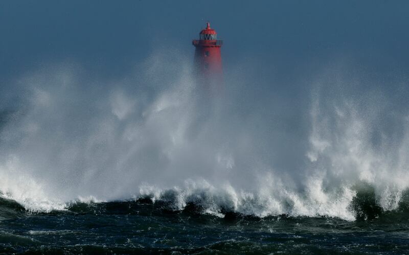 Waves break on the shoreline in front of Poolbeg Lighthouse as Storm Eunice brought gale force winds across the country in February 2022. Photograph: Alan Betson/The Irish Times

