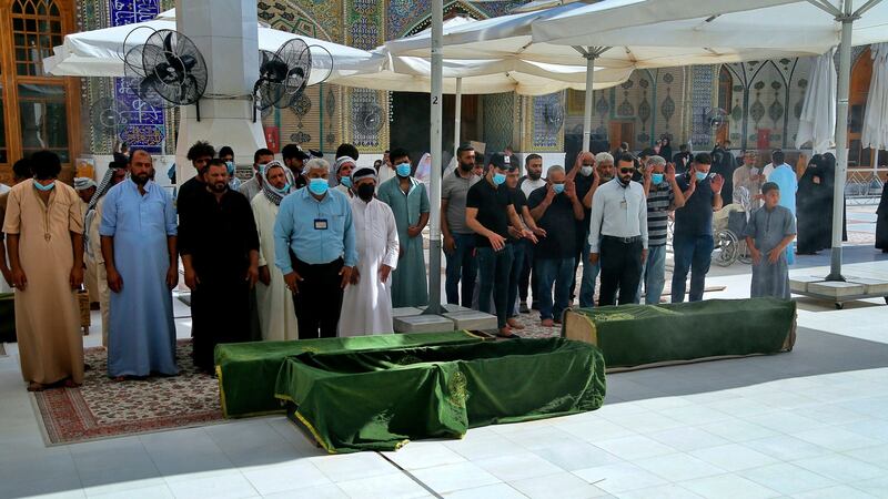 Mourners prepare to bury hospital fire victims in Najaf, Iraq. Photograph: Anmar Khalil/AP