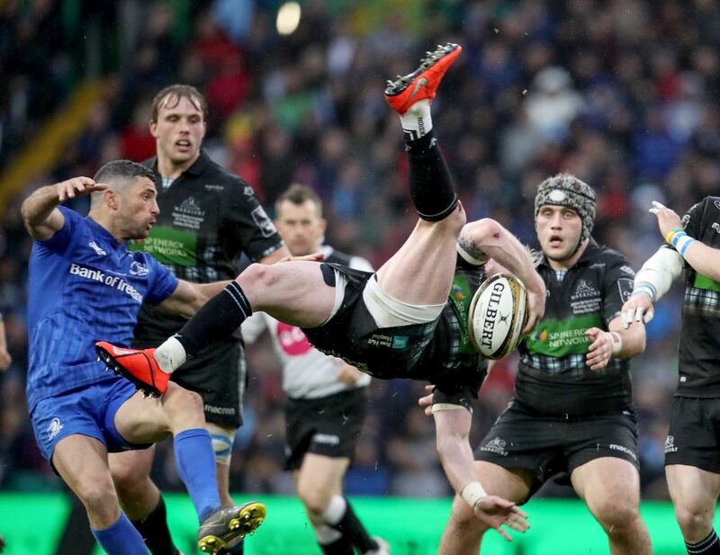 Glasgow Warriors’ Stuart Hogg falls to the ground after a tackle from Rob Kearney. Photograph:   Dan Sheridan/Inpho