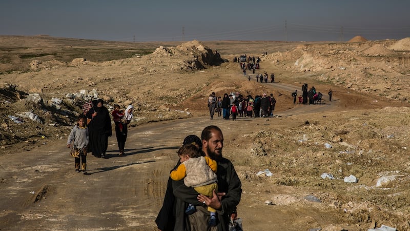 People fleeing clashes between Iraqi security forces and Islamic State fighters walk through the southern outskirts of Mosul, Iraq, on March 3rd, 2017. Photograph:  Ivor Prickett/The New York Times