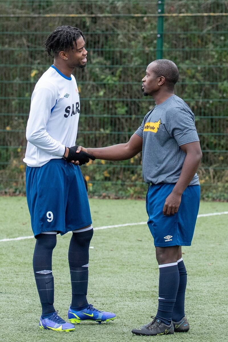 Sari (Sport Against Racism Ireland) skipper Emmanuel Nkencho shakes hands with Fare (Football Against Racism Europe) captain Oscar Sibanda.
