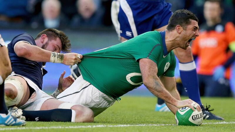 Rob Kearney celebrates scoring a try against Scotland.