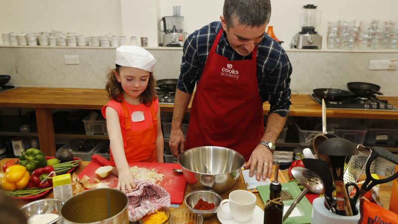 Damian Cullen helps his five-year-old daughter – or maybe more accurately Eve helps her father – to make ‘Bangin’ Burritos with Steak and Mexican Rice’ at Dublin’s Cooks Academy as part of ‘Cook Along with Ben’s Beginners’, which promotes children and parents cooking together. Photograph: Robbie Reynolds