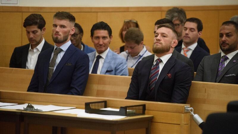 UFC fighters Conor McGregor and Cian Cowley wait to plead guilty to disorderly conduct during the court hearing. Photograph: Charles Eckert/Pool via Reuters