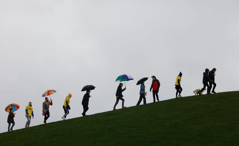 Charlie Bird and supporters walk up the side of the Papal Cross mound at the start of a 5km walk in the Phoenix Park on Saturday.  Photograph: Alan Betson 

