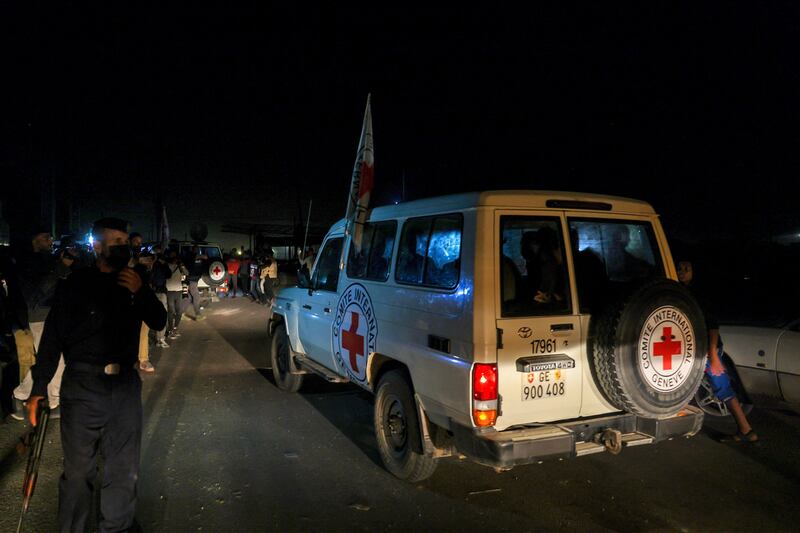 International Red Cross vehicles reportedly carrying Israeli hostages released by Hamas cross the Rafah border point in the Gaza Strip on the way to Egypt, from which they would be flown to Israel to be reunited with their families, on Friday. Photograph: Mohammed Abed/AFP