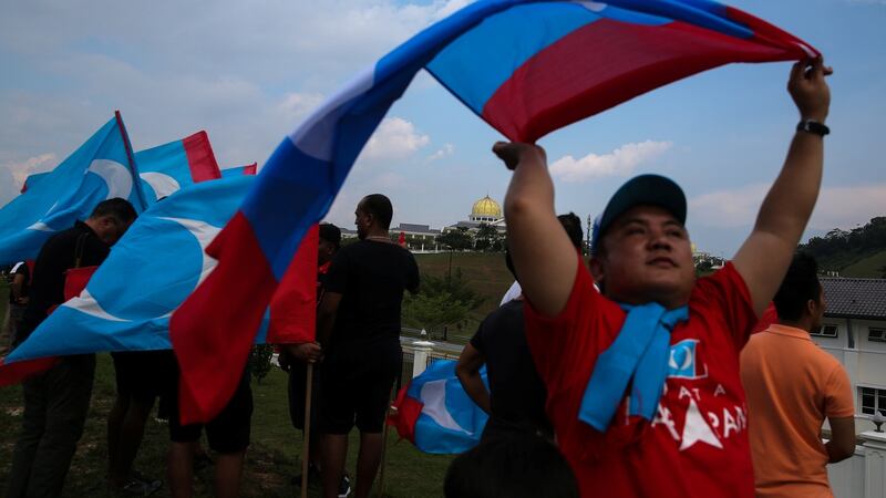Supporters of Mahathir Mohamad  outside the National Palace in Kuala Lumpur. Photograph:  Athit Perawongmetha/Reuters