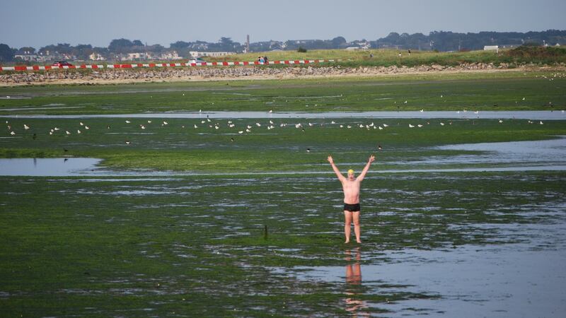 Patrick Corkery celebrates conpleting the swim. Photograph: Conor McKenna