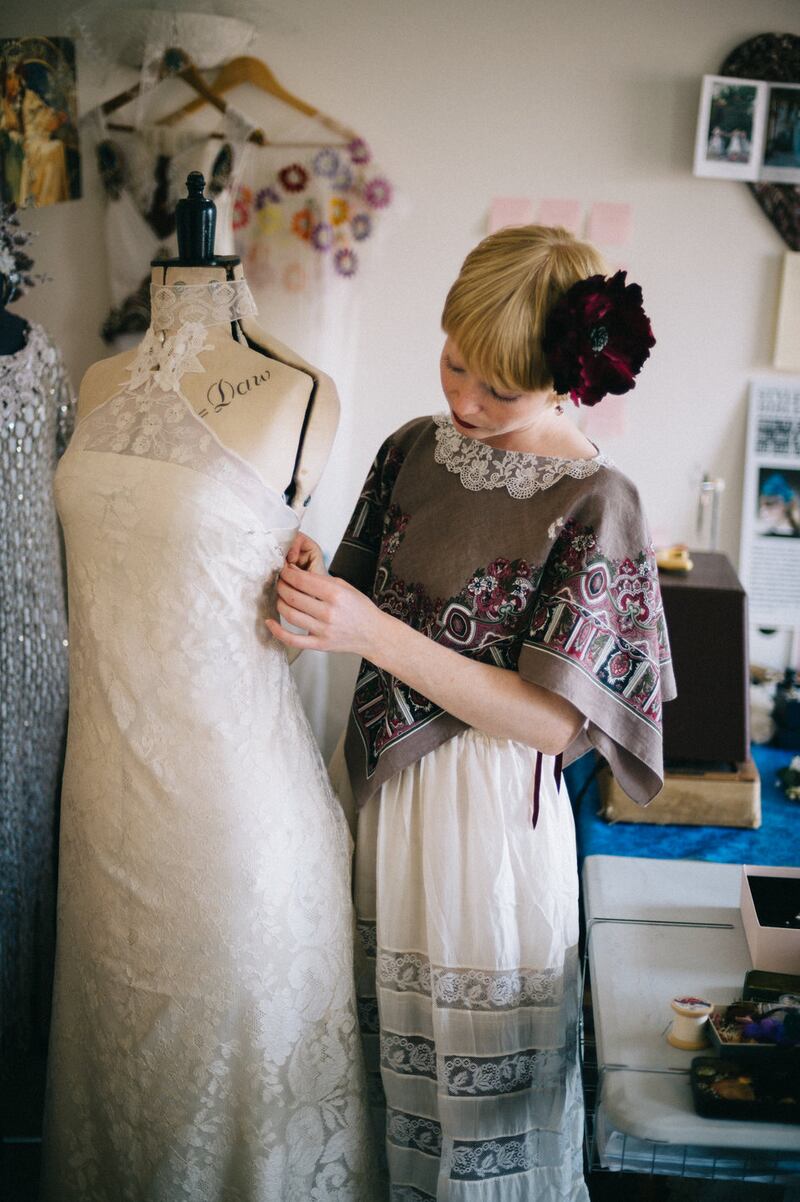 Alice Halliday at work draping on a mannequin