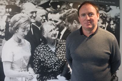 Patrick Grennan in front of a photograph of his grandmother Mary Ryan meeting President John F Kennedy in June 1963.
