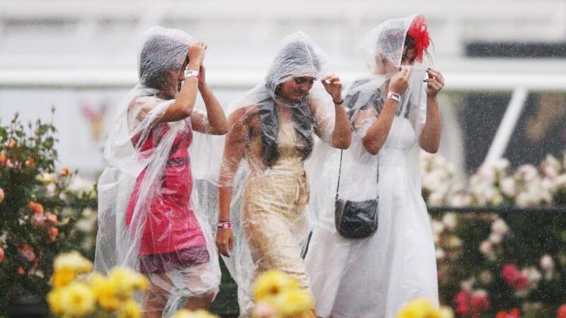 Racegoers endure the wet conditions. Photo: Michael Dodge/Getty Images