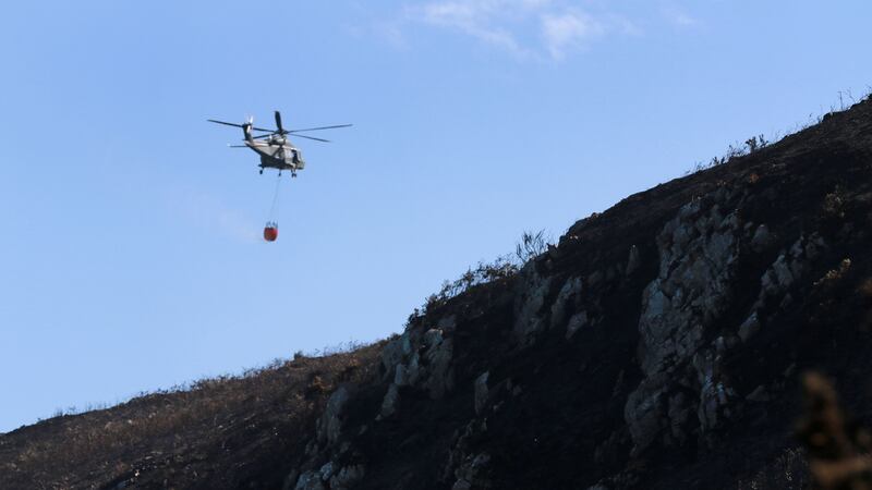 An Air Corps helicopter assists firefighters on Bray Head. Photograph: Nick Bradshaw for The Irish Times