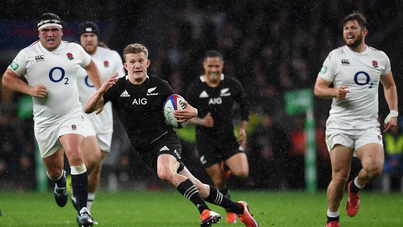 New Zealand’s Damian McKenzie skips through the England pack during their win at Twickenham on Saturday. Photo: Andy Rain/EPA