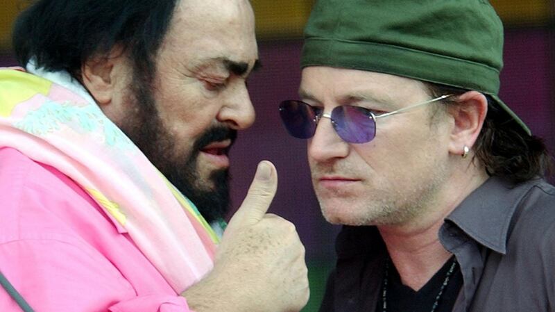 Bono speaks with Pavarotti during rehearsal for the Pavarotti & Friends 2003 annual charity concert at the Novi Sad Park in Modena, Italy. Photograph: AP Photo/Alberto Pellaschiar