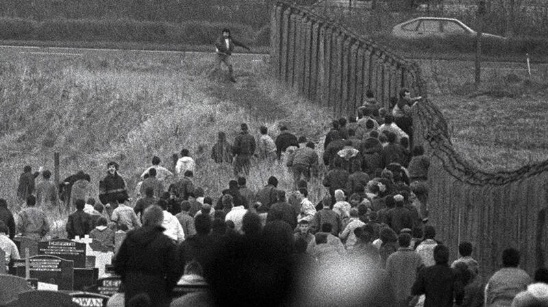 Michael Stone is pursued by mourners in Milltown cemetery in Belfast during his attack on the funeral of three IRA members on March 16th, 1988. Photograph: Peter Thursfield
