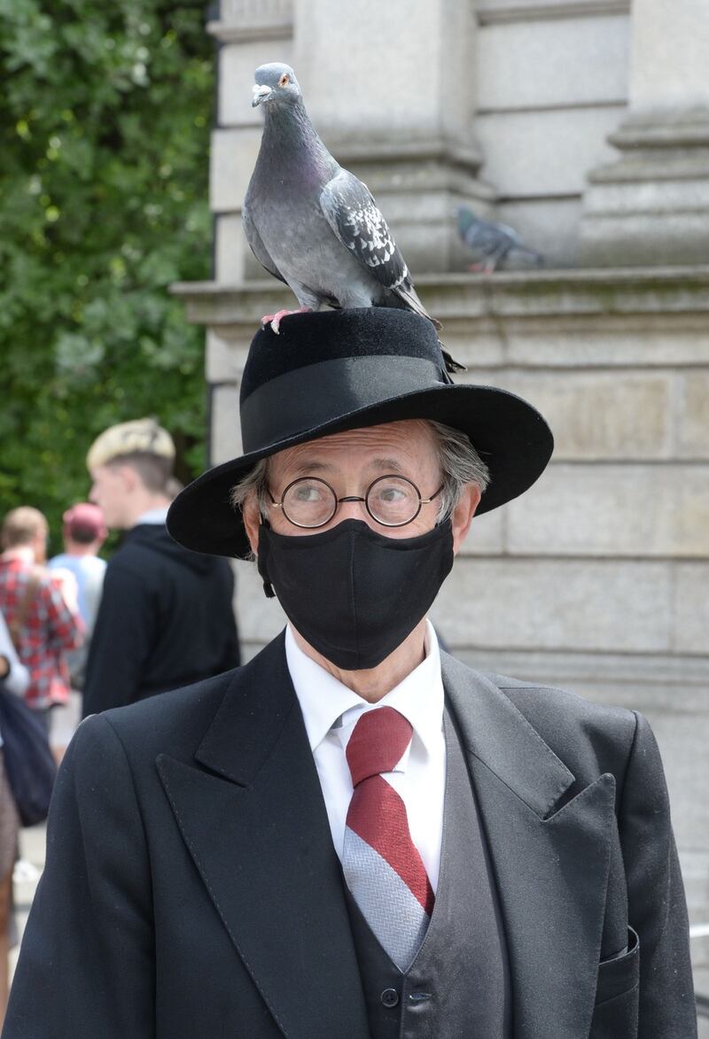 PIGEON'S BLOOMING CHEEK: John Shevlin, a resident of North Great Georges Street, where the James Joyce Centre is located, dresses as James Joyce at St Stephens Green on Bloomsday 2020. Shevlin has recently recovered from Covid-19. Photograph: Alan Betson