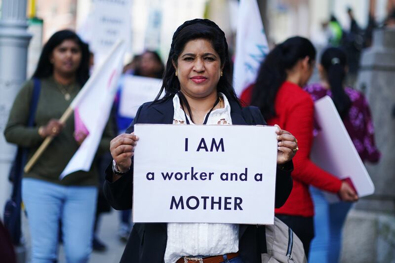 Nursing home worker Shiji Joseph, from India, participates in the Families Belong Together campaign demonstration outside the Department of Justice on Wednesday. Photograph: Brian Lawless/PA Wire 
