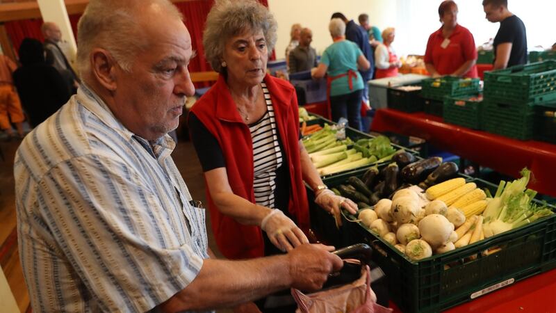Eduard (L), a retired truck and machine driver, chooses groceries with the help of volunteer Brita Blaesing at a food distribution point organised by the Berliner Tafel on August 24th. Photograph: Sean Gallup/Getty Images