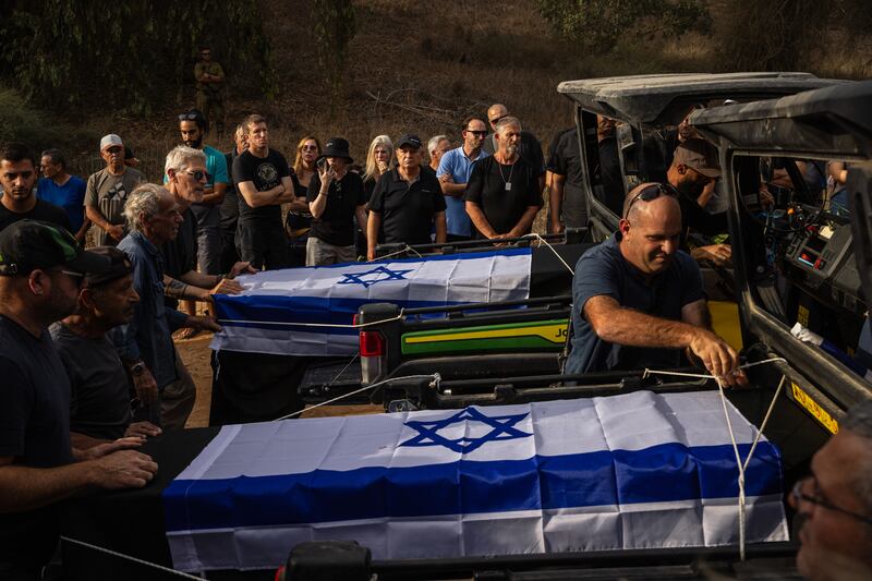 Mourners attending the funeral for Lili and Ram Itamari, who were killed by Hamas militants in Kfar Azza in Ruhama, Israel, on October 7th. Photograph: Tamir Kalifa/The New York Times
                      