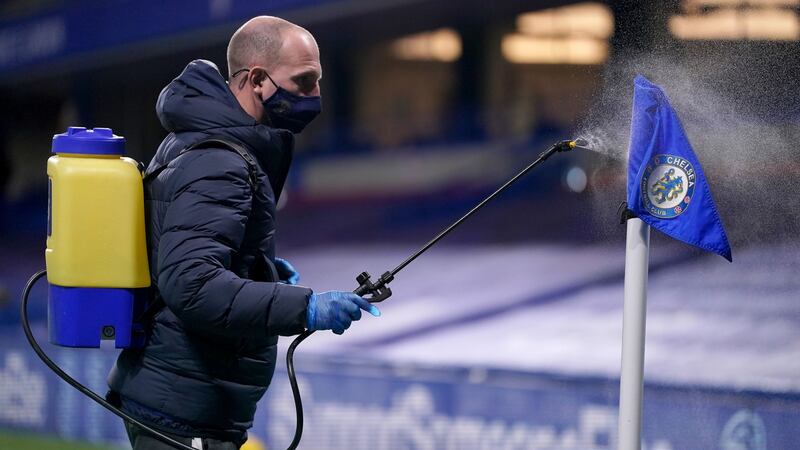 The corner flags are disinfected at half-time during the Premier League match at Stamford Bridge. Photograph:  John Walton/PA Wire