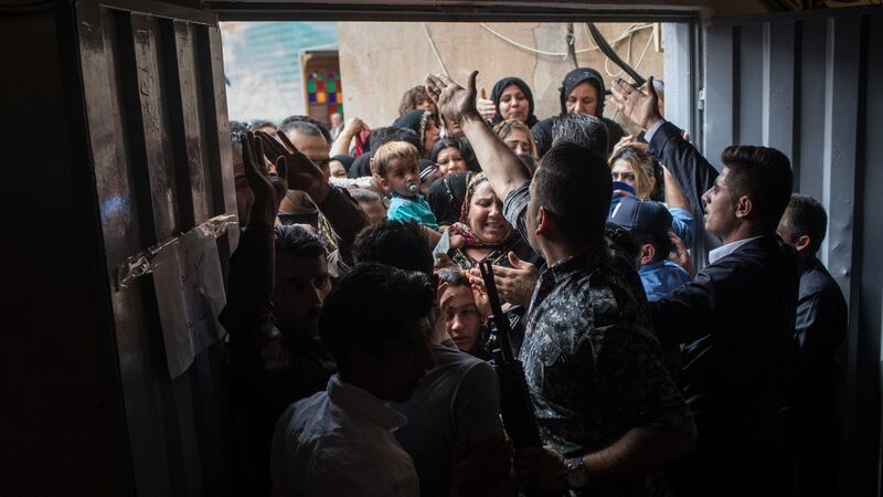 Police and security staff try to keep people from forcing their way into a voting station on September 25th, 2017 in Erbil, Iraq. Despite strong objection from neighbouring countries and the Iraqi government, some 5 million Kurds took to the polls  across three provinces in a historic independence referendum. Photograph: Chris McGrath/Getty Images