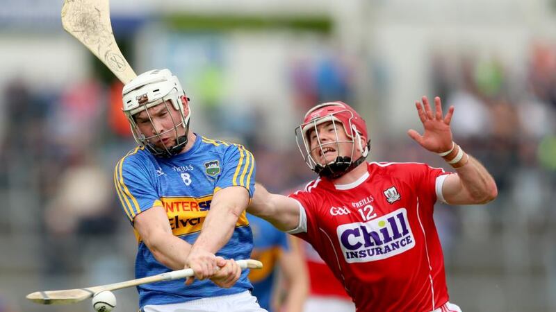 Tipperary’s  Brendan Maher and Daniel Kearney of Cork. Photograph:  Inpho: James Crombie