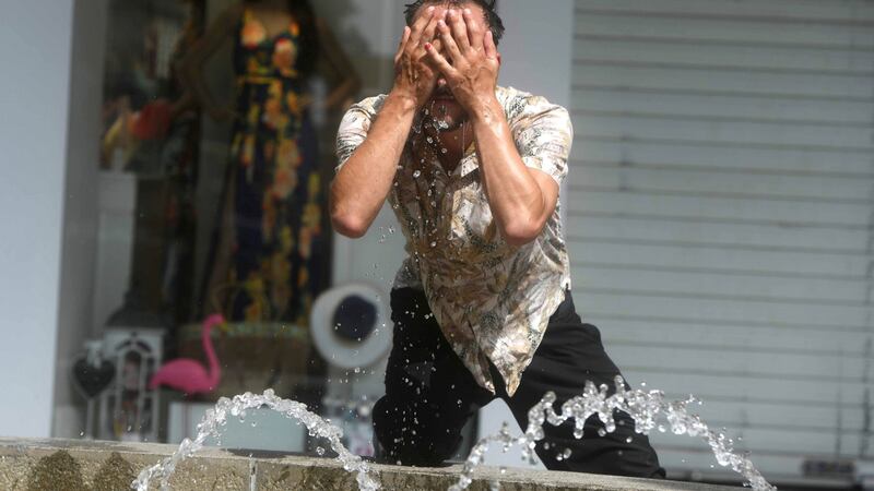 Cooling down in a fountain due to high temperatures in Cordoba, southern Spain. Photograph: Reuters