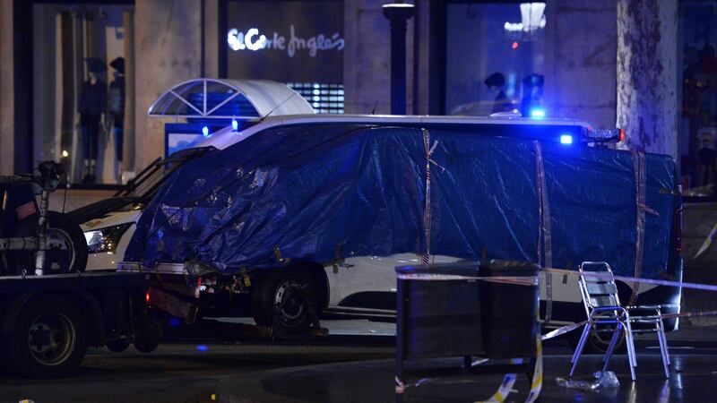 The van which was driven into a  crowd, killing at least 13 people and injuring around 100 others is towed away. Photograph: AFP